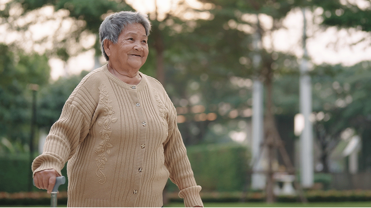 An elderly lady with a walking stick. Photo.
